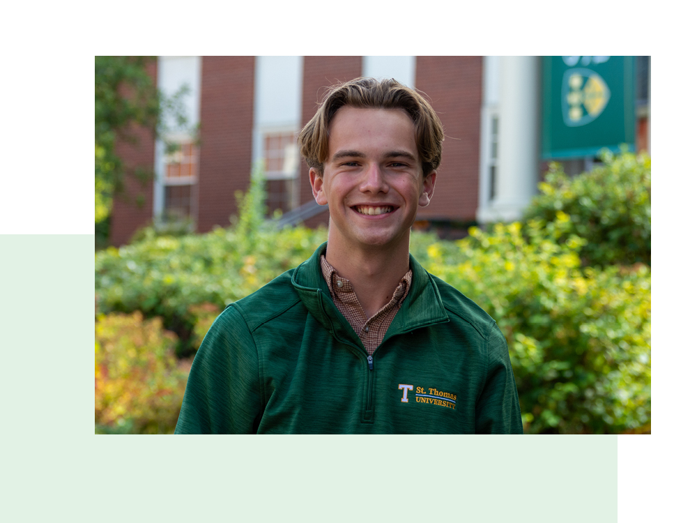 Photo of Ethan Nylen a STU grad on campus in a STU sweater