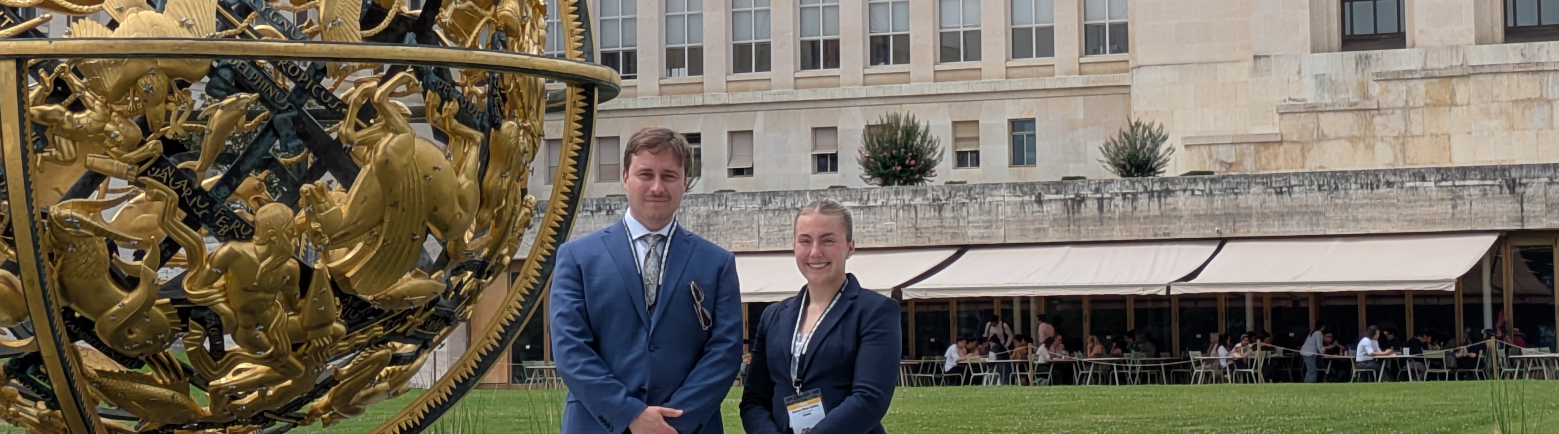 A male student and a female student stand outside the UN in Geneva