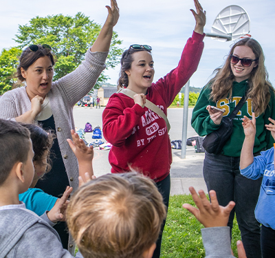 Three Bachelor of Education STUdents with a group of K-3 elementary school students at sustainability event- STUzapalooza in Saint John