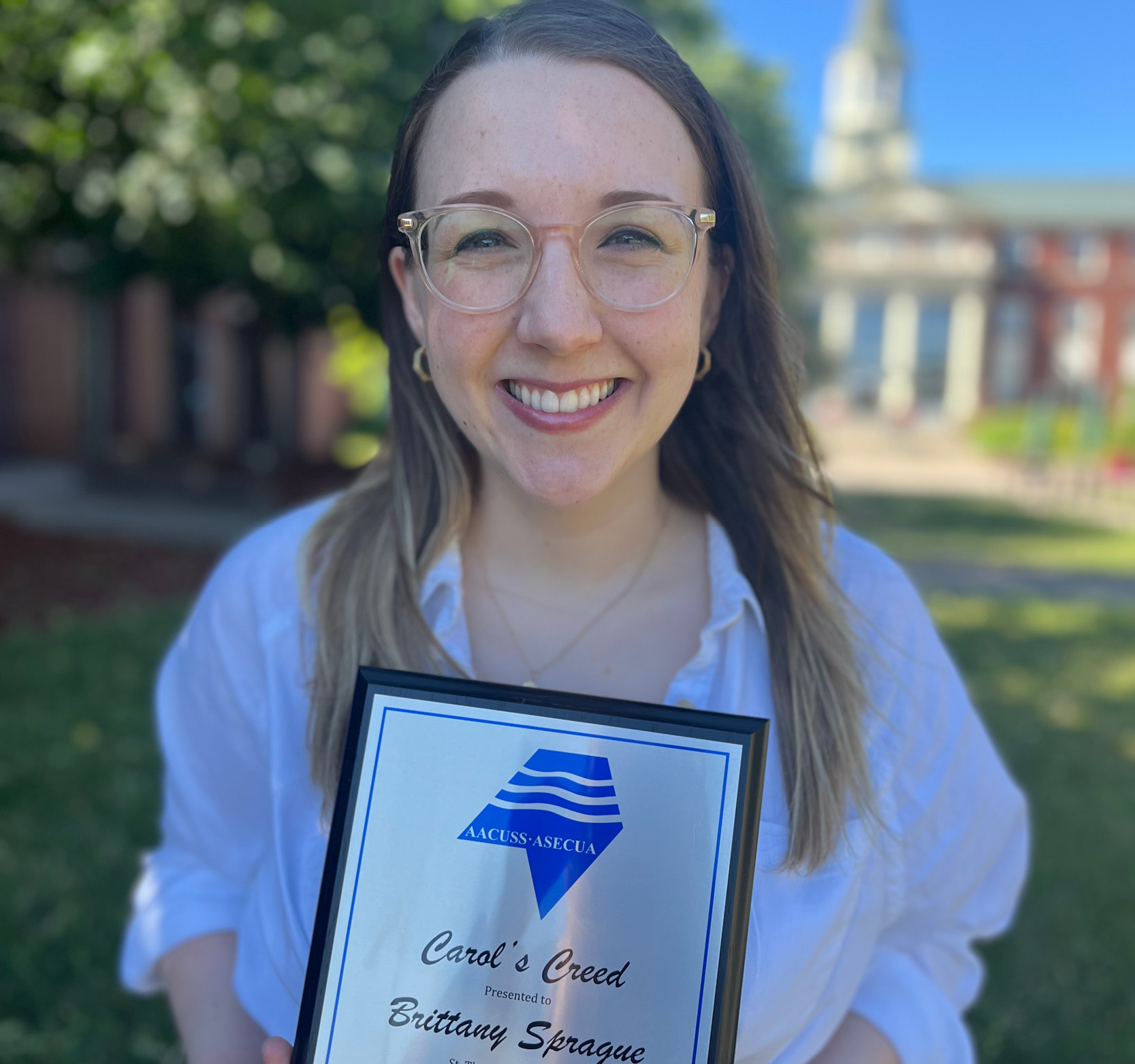 Brittany Sprague holding a plaque