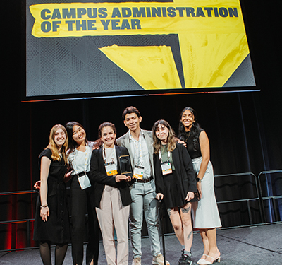 Enactus STU members on stage receiving Campus Administrator of the Year Award