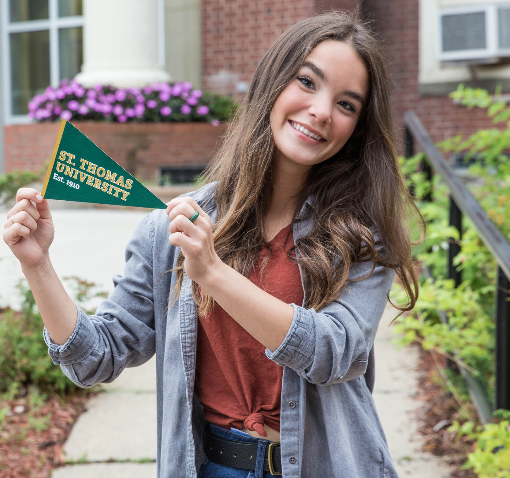 Photo of student holding STU pennant