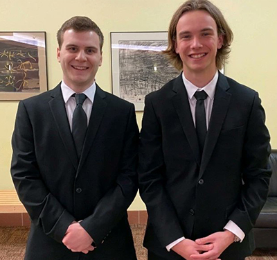 Two male students standing side by side