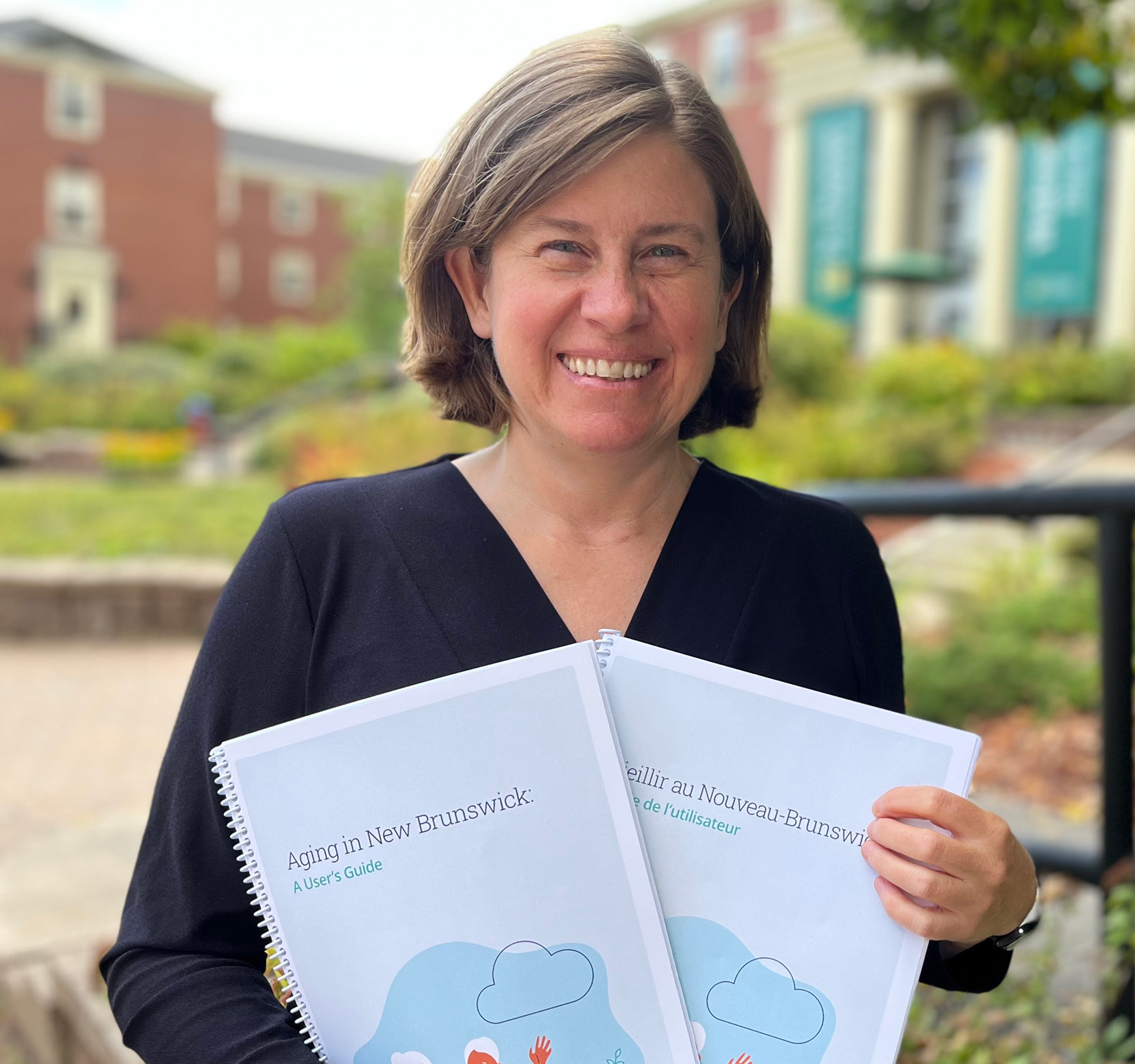 STU Professor Michelle Lafrance Holding her Book