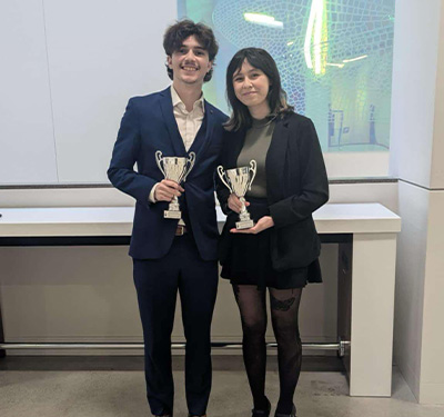 Picture of winning STU moot team - Nicholas and Ellie with trophies