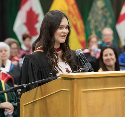 Photo of Leanne Hudson delivering valedictory address