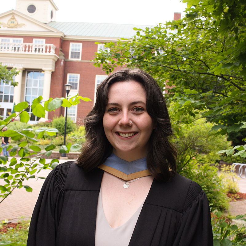 A student wearing a robe and hood