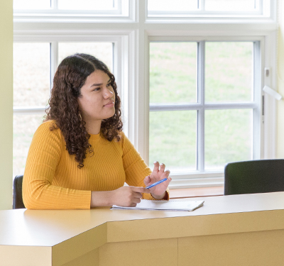 a photo of Monica, student, in class listening 