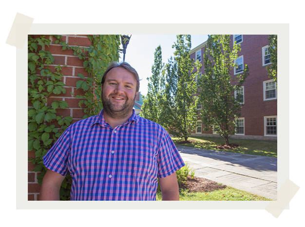 Dr. Jamie Gillie standing outside next to campus buildings