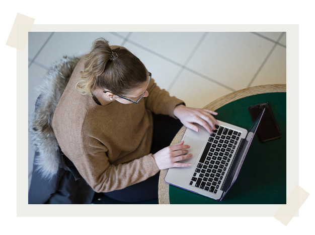 An aerial shot of a student typing on a laptop