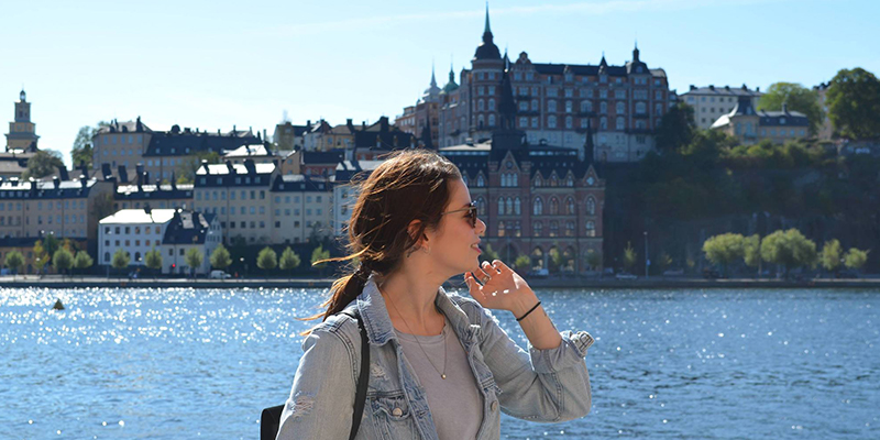 Female student overlooking a lake in Sweden