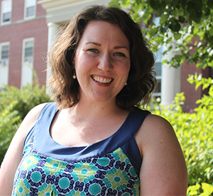 Heather MacDonald smiling in front of campus