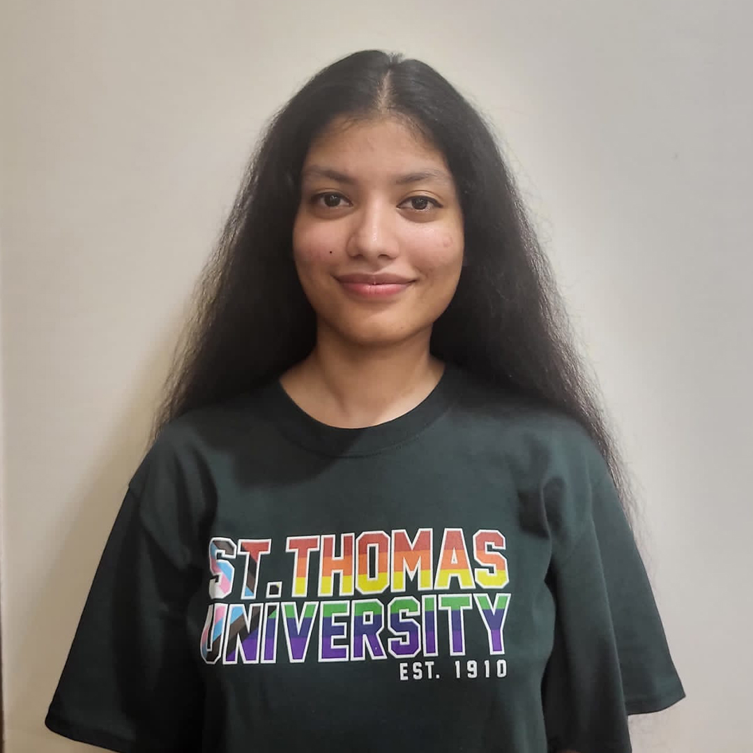 Scholarship recipient student with rainbow STU shirt