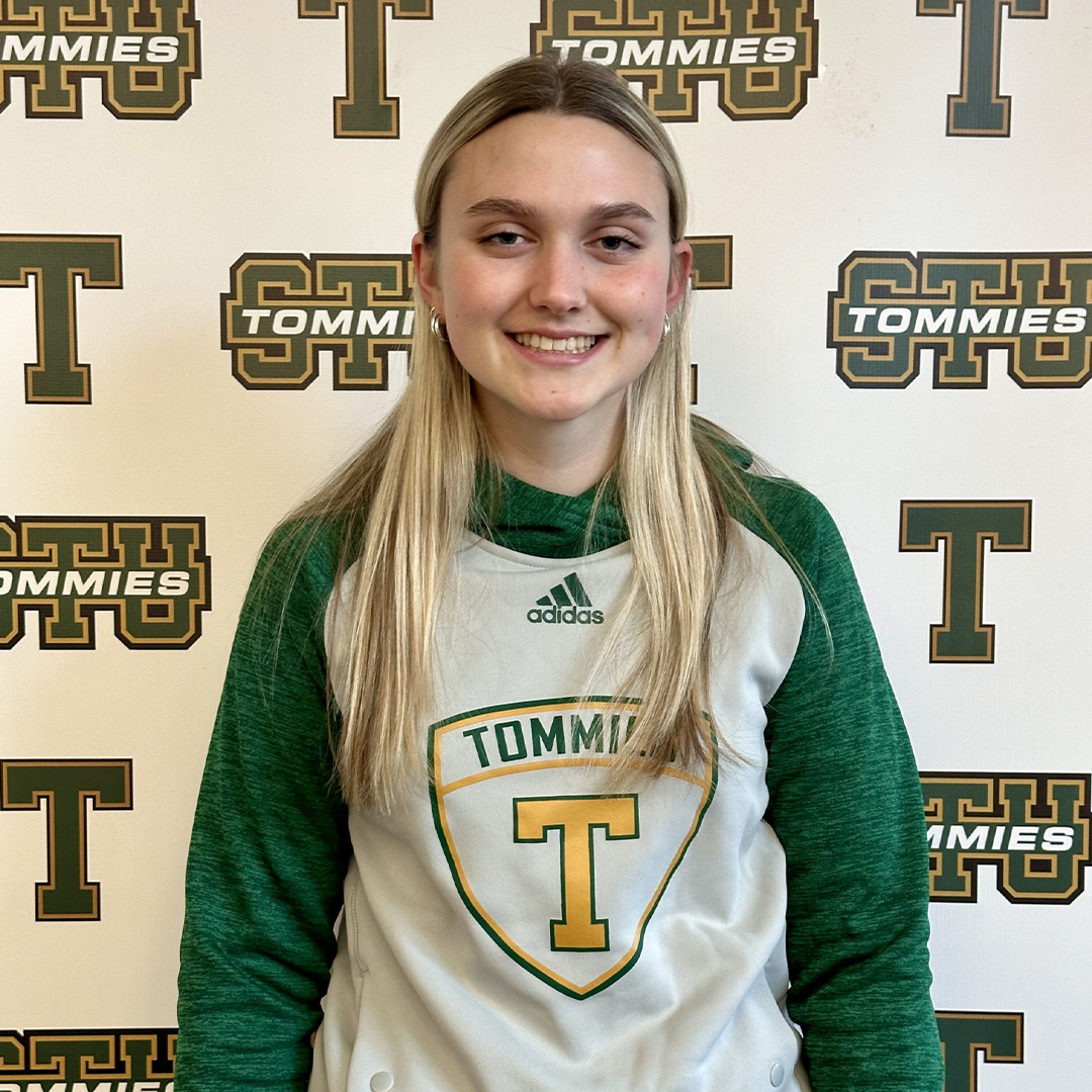 Photo of scholarship recipient with STU Tommies Background and Tommies hoodie