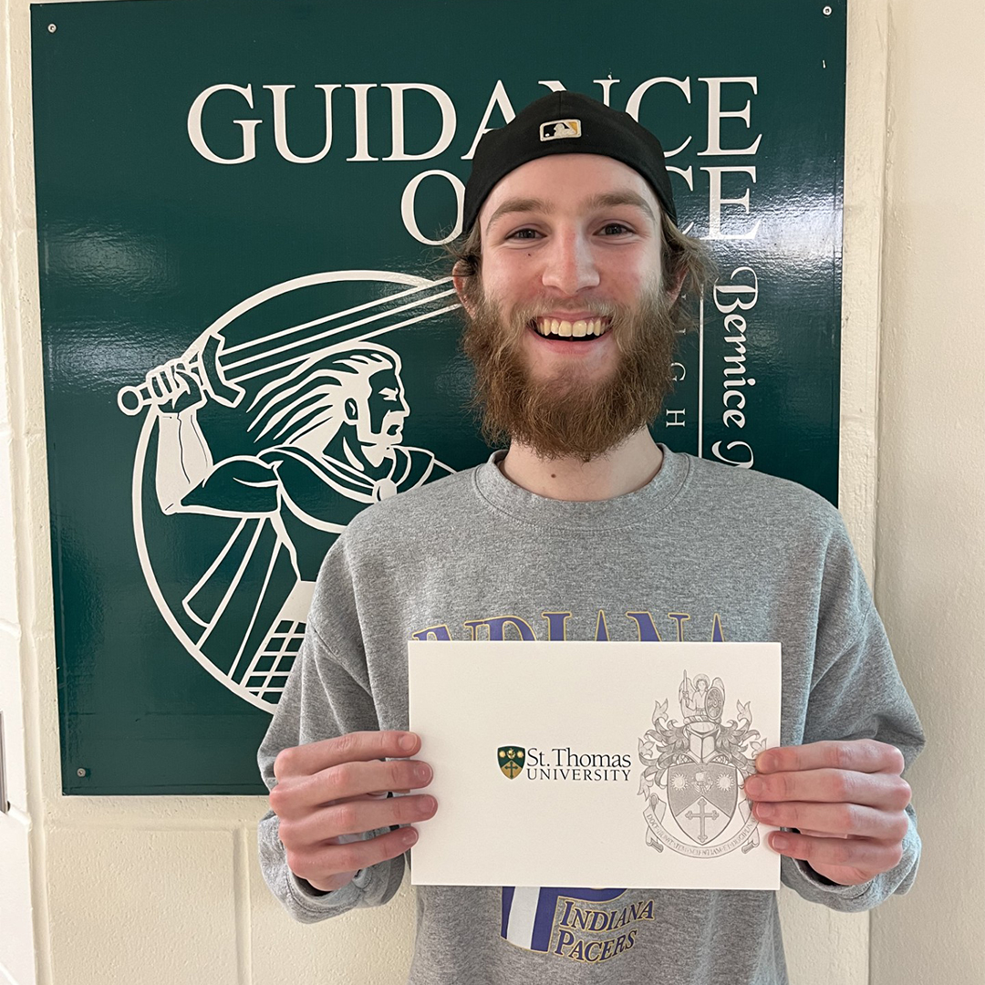 Scholarship recipient student smiling and holding scholarship letter