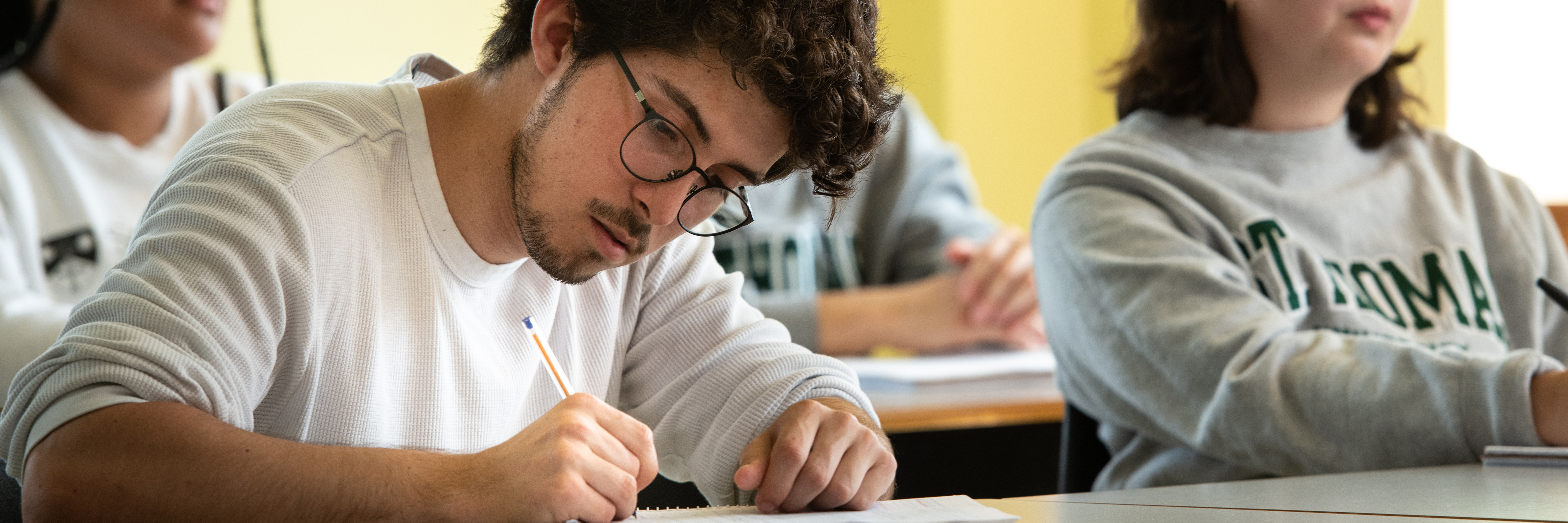 student taking notes in class