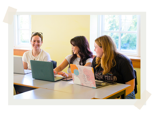 Three students smiling in class