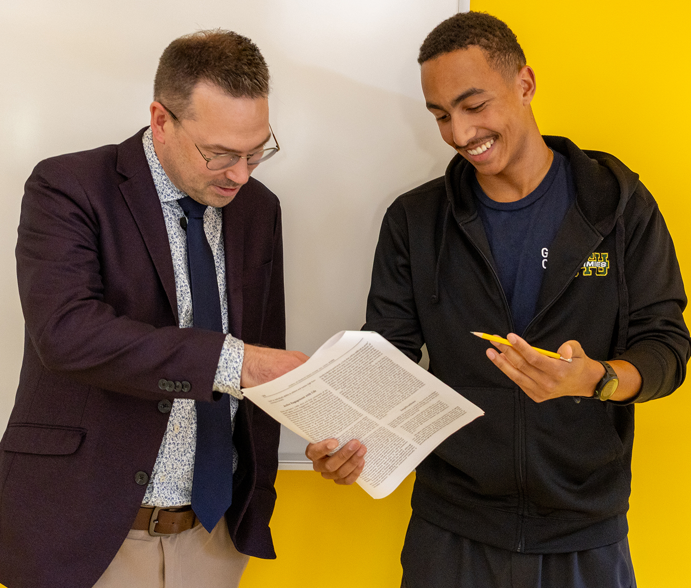 student and professor speaking in class