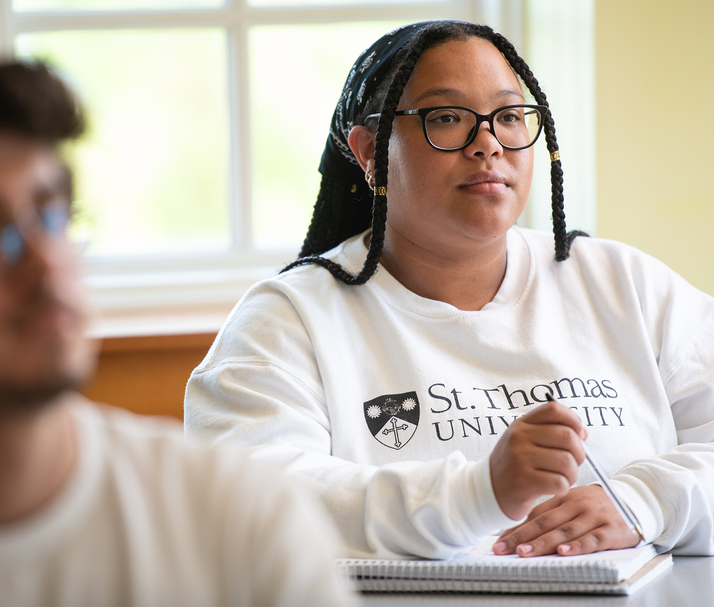 student taking notes in class