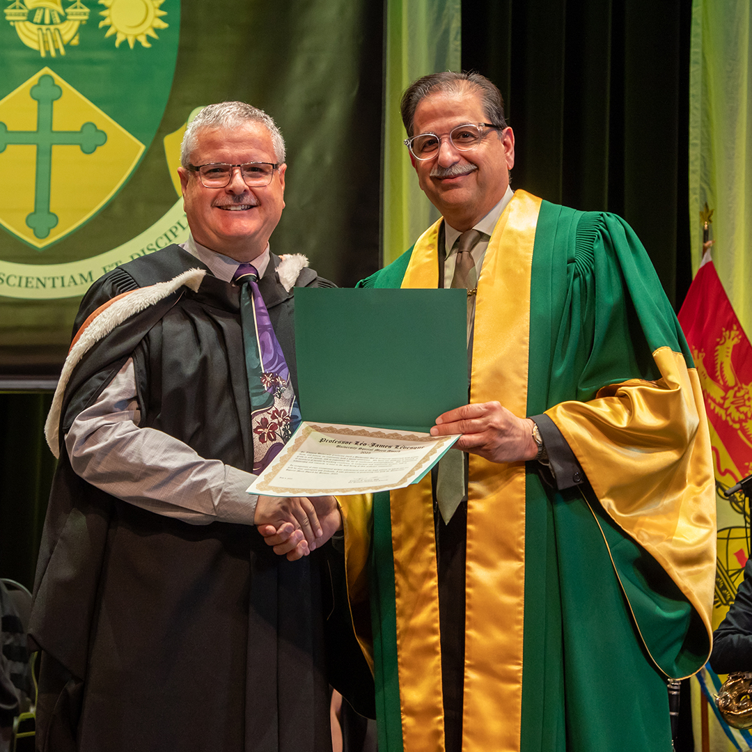 Professor Léo-James Lévesque receiving the University Service Award