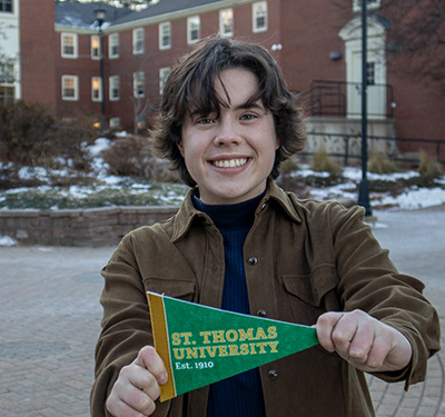 Aidan Steeves holding STU pennant