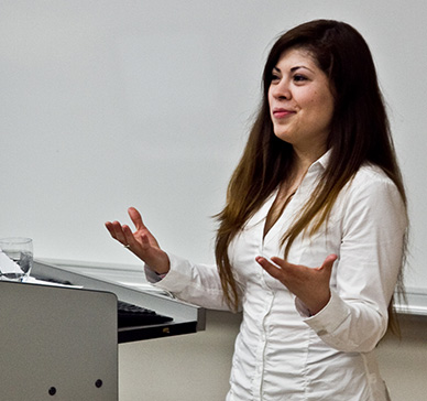 A student standing at a podium delivering a presentation