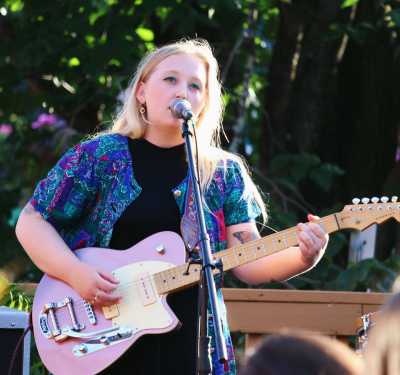 Jerry-Faye singing and playing guitar